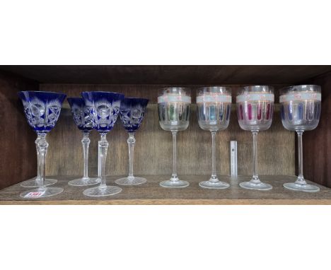 A set of five Continental blue overlay goblets, 20cm high, (rim chips to four); together with another set of four stained gla
