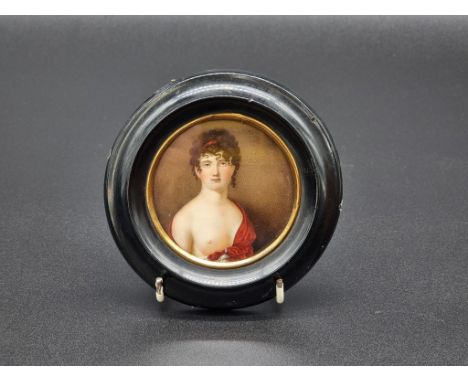 European School, 19th century, bust length portrait miniature of a classical female semi-nude, on porcelain, 8.1cm diameter.