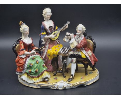 A Continental porcelain figure group, 21cm high, (repair to banjo).