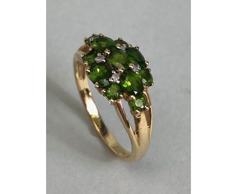 9ct Gold ring set with green Tourmaline gemstones with pierced shoulders size approx 'M'