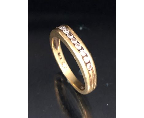 18ct Gold contemporary style ring set with band of 9 diamonds flanked with fluted shoulders size approx 'L' & 3.5g