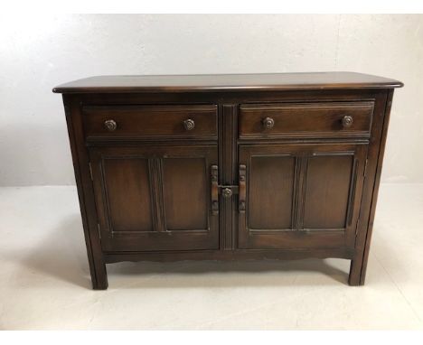 20th century furniture, Ercol dark Elm, Cambrewood design sideboard, double cupboard with drawers above one with sliding cutl