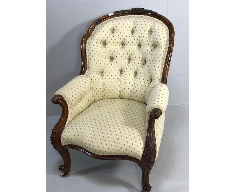 Antique furniture, !9th century padded fabric and button  scoop back armchair, carved walnut surround and legs with ceramic c