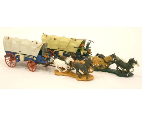 Two Britains 7616 Wild West Pioneer Covered Wagons, blue wagons, with red wheels, white tilts with flaming arrows, driver and