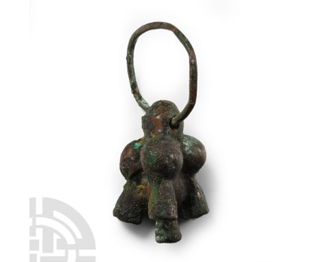 9th-7th century B.C. Comprising a cluster of four spheres with flared legs below, pierced to accept a bronze suspension loop.