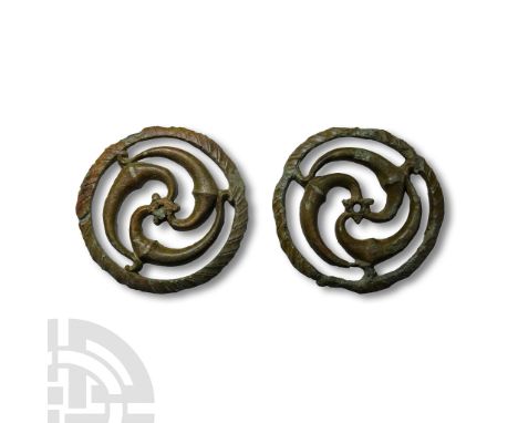 2nd-3rd century A.D. Each a D-section disc with central triskele and coiled arms, segmented detailing to the outer face. Cf. 