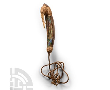 New Zealand, 18th-19th century A.D. An Oceanic fish-hook comprising a D-section wooden shank with polished shell panel (the l