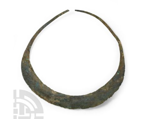 9th-12th century A.D. Broad flat-section collar with tapering ends, hook-and-eye closure (eye absent); traces of mineralise h