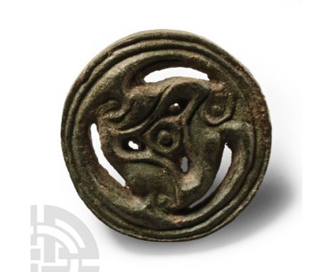 1st century B.C.-1st century A.D. Discoid with ribbed outer ring enclosing a La Tène triskele with central hub; mounting stud