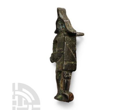 1st-3rd century A.D. Plate brooch formed as an advancing gladiator with large rectangular shield, triangular helmet, gladius 