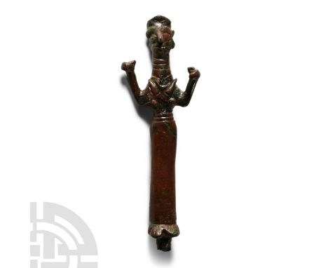 2nd-1st millennium B.C. Columnar in form with pinched facial features, bisected headdress, horns to the collar and belt to th