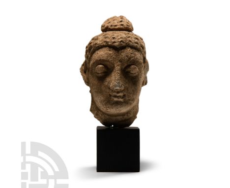 3rd-5th century A.D. Modelled with fleshy features, heavy lidded eyes and strong aquiline nose, wavy hair drawn up in an ushn