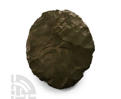 Neolithic Period, circa 6th-4th millennium B.C. Biconvex in profile with rippling to both faces.  256 grams, 13.5 cm (5 1/4 i