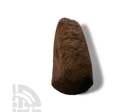 Neolithic Period, circa 4th-3rd millennium B.C. Squat in profile with curved cutting edge, rounded butt; chipped.  197 grams,