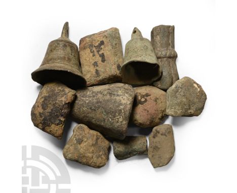 12th-15th century A.D. Comprising nine stubby cast legs from bronze cooking pots, and a small bell with pierced knop finial. 