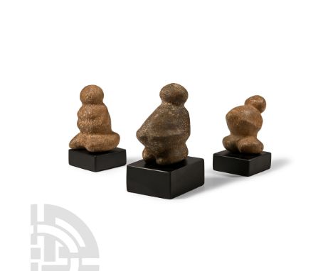 Neolithic Period, circa 6th-4th millennium B.C. or later. Group of three carved and polished figurines with rounded heads and