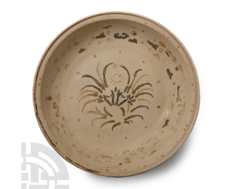 15th century A.D. Broad shallow bowl with substantial basal ring, band of cloud pattern ornament enclosing a floral motif. 1.