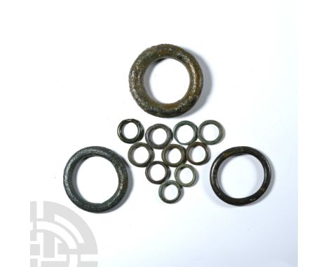 3rd-1st century B.C. Proto-money or harness ring group comprising thirteen round, lozenge, and flat-section rings.  200 grams