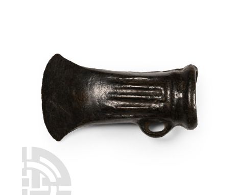 Britain, 2nd millennium B.C. Hollow-formed and rectangular in section with rim to the mouth, tapering faces with three raised