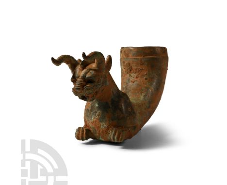 5th-4th century B.C. With a curved tapering body, the protome formed as a mythical horned lion with folded wings, mouth with 