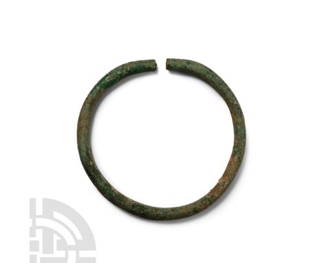 Late Bronze Age, 1st millennium B.C. Round in section with notched finials.  97 grams, 95 mm (3 3/4 in.). [No Reserve]Acquire