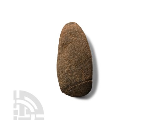 Neolithic Period, circa 4th-3rd millennium B.C. With broad curved edge and rounded butt; scored.  113 grams, 82 mm (3 1/4 in.