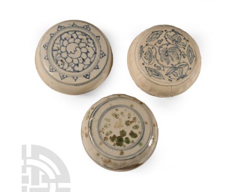 15th century A.D. Comprising three powder boxes with painted flowers to the lid.  467 grams total, 75-79 mm (3 - 3 1/8 in.). 