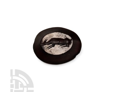 1st-2nd century A.D. Ellipsoid in plan with intaglio hound crouching.  1.62 grams, 15 mm (5/8 in.).From the private collectio