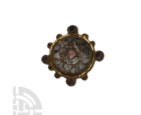 Circa 11th century A.D. With circular frame enclosing a cloisonné enamel cinquefoil design in shades of blue and red, radiati