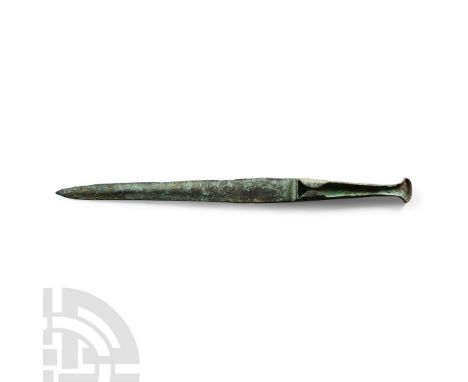 Circa 1000 B.C. With lentoid section blade tapering to a point; the hilt hollowed both sides to accept an organic handle. See