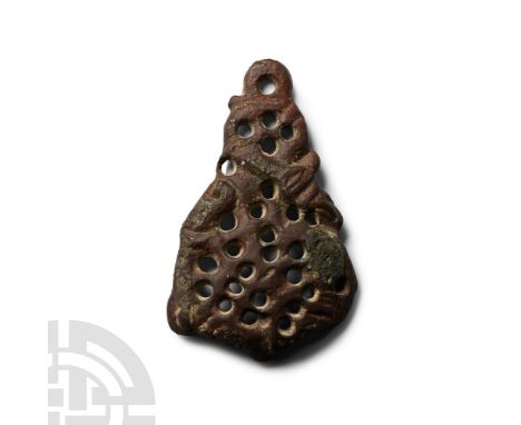 11th century A.D. Triangular in profile with openwork Urnes Style interlace, attachment pins to lower corners (one absent). C