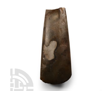 Neolithic Period, circa 4th-3rd millennium B.C. Finely polished, lentoid in section with broad cutting edge; some chipping to