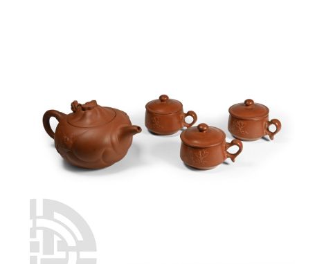 20th century A.D. Comprising: squat teapot with loop handle and short spout, low-relief dragon detailing to each side, conica