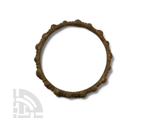 Late Bronze Age, 1st millennium B.C. D-shaped in section with radiating knops and interstitial transverse ribs.  39 grams, 70