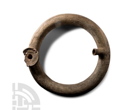 2nd-1st millennium B.C. Hollow-formed ceramic ring with pierced funicular spout, lateral vent.  1.35 kg, 34 cm (13 3/8 in.). 