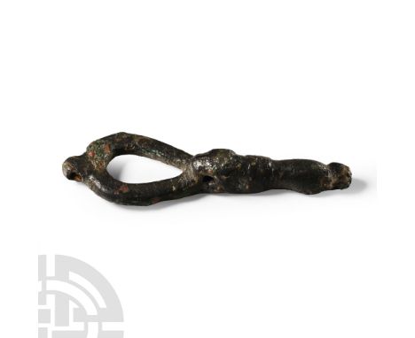 11th century A.D. With looped bow and pierced lug above, balustered shank with biting-beast detailing, pierced lug below. Cf.