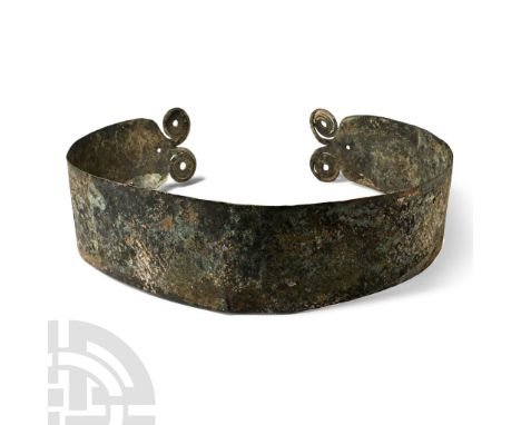 9th-7th century B.C. A broad hammered military belt or cuirass band with plain surface, the terminals shaped as a double spir