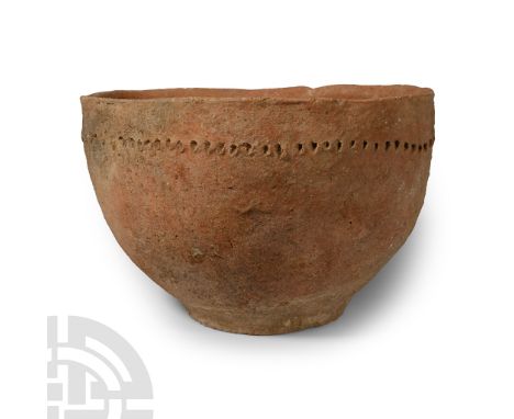 Early Bronze Age, 3rd-2nd millennium B.C. With wide body and low foot, decorative impressed-point band with four low lugs bel