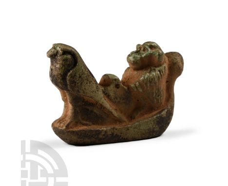 Late Period, 664-332 B.C. This small statuette is modelled in the round, comprising a small barque with a seated baboon and a