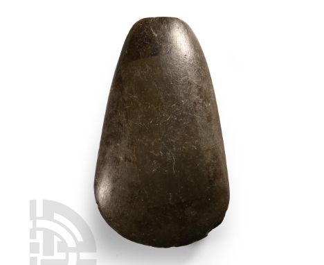 Neolithic Period, circa 4th-3rd millennium B.C. Highly polished with broad convex cutting edge, body tapering to a narrow squ