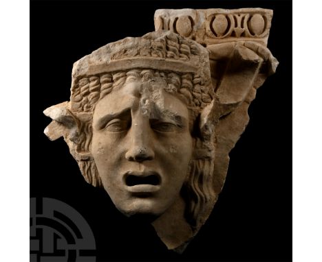 2nd century A.D. Carved fragment with a female tragedy theatre mask modelled in the half-round, features strongly delineated,