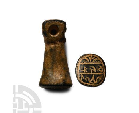 6th-8th century A.D. Formed as a fist with transverse hole, Greek legend to the flat end.  8.3 grams, 22 mm (7/8 in.).From th