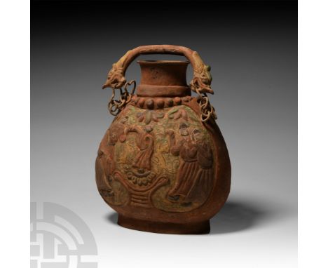 20th century A.D. An undated, archaic style funerary vessel with flask-shaped body, pierced lug handles at the shoulders susp