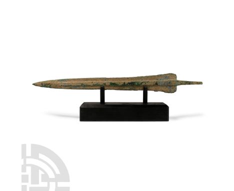 Circa 1st millennium B.C. Comprising a slender blade with a raised midrib extending towards the short tang, broad rounded sho