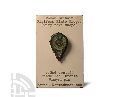 Circa 2nd century A.D. Piriform type with open roundel to centre, scalloped edge, traces of blue enamel to plaque; mounted on