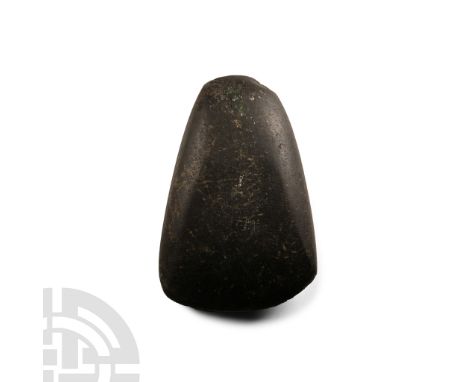 Neolithic Period, circa 4th-3rd millennium B.C. or later. Triangular in plan with rounded butt and broad edge.  179 grams, 86