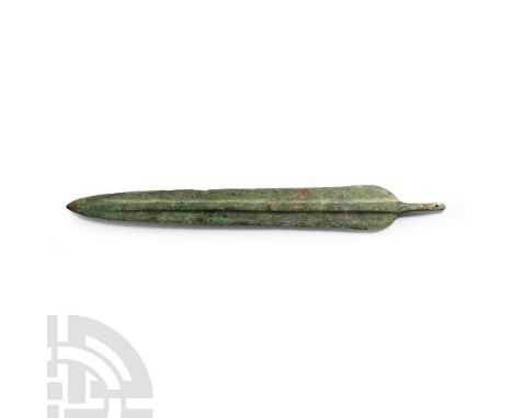 1st millennium B.C. With rounded shoulders and square-sectioned mid-rib running to the blade tip; short tang with fastening h