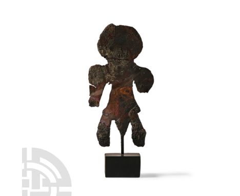 Early 1st millennium B.C. Sheet-bronze figure with large discoid head stubby arms, triangular phallus; mounted on a custom-ma