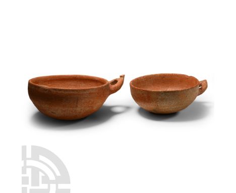 Late Bronze Age, 16th-12th century B.C. Comprising two russet-coloured each with stirrup-shaped handle below the rim. Cf. Ami