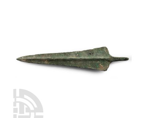Circa 1000 B.C. Tapering with rounded shoulders and flattened mid-ribs, tapered square sectioned tang pierced at the tip. See